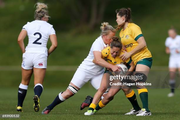 Cobie-Jane Morgan of Australia is tackled by Izzy Noel-Smith of England during the Women's International Test match between the Australian Wallaroos...