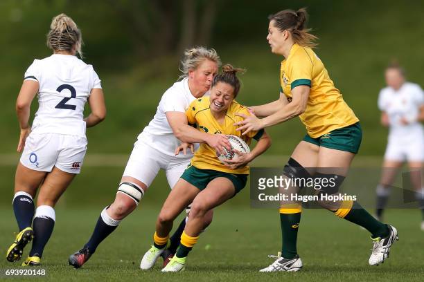 Cobie-Jane Morgan of Australia is tackled by Izzy Noel-Smith of England during the Women's International Test match between the Australian Wallaroos...