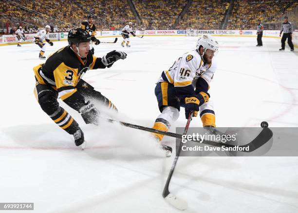 Olli Maatta of the Pittsburgh Penguins tips the puck away from Pontus Aberg of the Nashville Predators during the first period of Game Five of the...