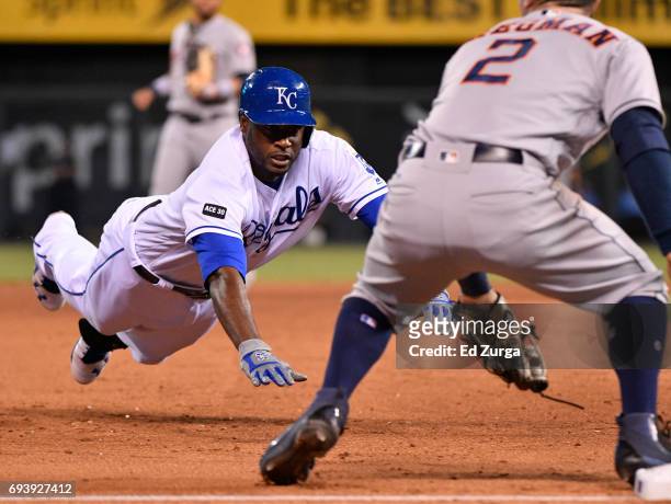Lorenzo Cain of the Kansas City Royals dives into third for a triple past Alex Bregman of the Houston Astros in the seventh inning at Kauffman...