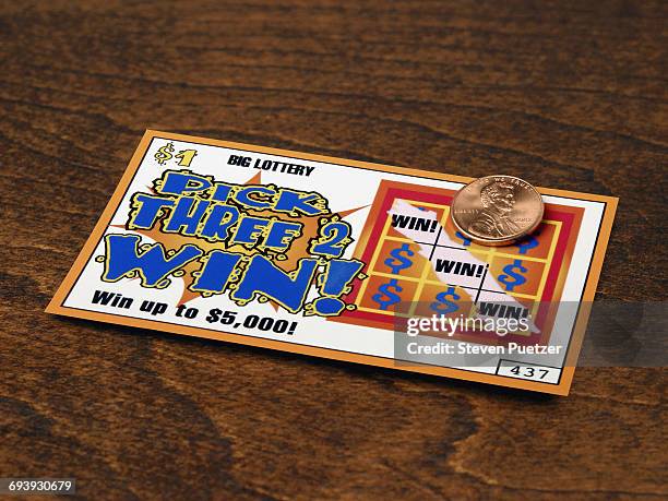 scratched off lottery ticket exposing winning tick - lotterie stock-fotos und bilder