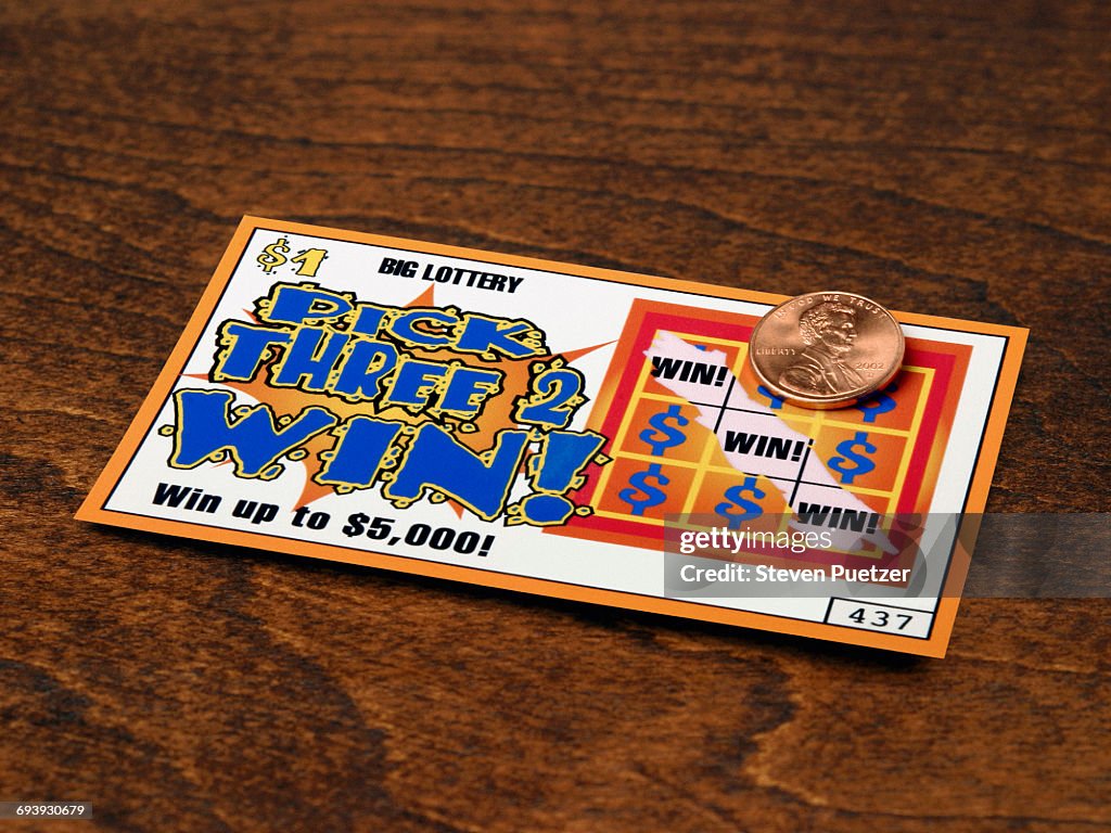 Scratched off lottery ticket exposing winning tick