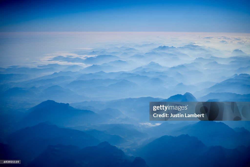 Austrian Alps from a plane window in morning