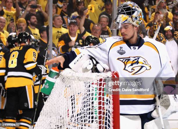 Goaltender Juuse Saros of the Nashville Predators reacts after giving up a goal by Ron Hainsey of the Pittsburgh Penguins during the second period of...