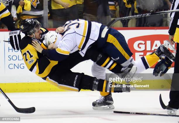 Roman Josi of the Nashville Predators and Evgeni Malkin of the Pittsburgh Penguins fight in the third period in Game Five of the 2017 NHL Stanley Cup...