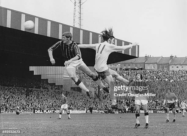 John McCormick of Crystal Palace challenges Arsenal centre forward Charlie George for the ball in the air during their English League Division One...