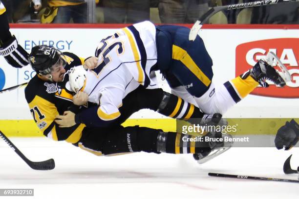 Roman Josi of the Nashville Predators and Evgeni Malkin of the Pittsburgh Penguins fight in the third period in Game Five of the 2017 NHL Stanley Cup...