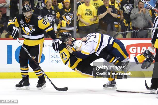 Roman Josi of the Nashville Predators and Evgeni Malkin of the Pittsburgh Penguins fight in the third period in Game Five of the 2017 NHL Stanley Cup...