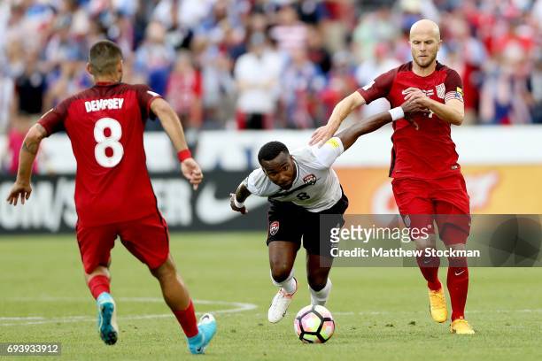 Khaleem Hyland of Trinidad & Tabago and Michael Bradley of the U.S. National Team fight for control of the ball in the first half during the FIFA...