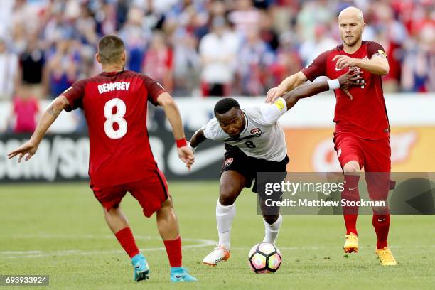 Khaleem Hyland of Trinidad & Tabago and Michael Bradley of the U.S. National Team fight for control of the ball in the first half during the FIFA...