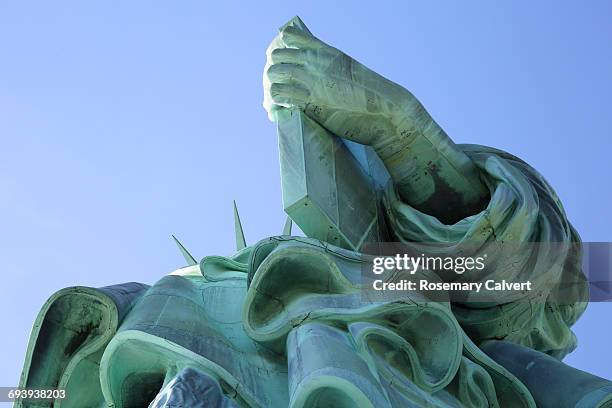 part of statue of liberty in close up & blue sky. - statue of liberty close up stock pictures, royalty-free photos & images