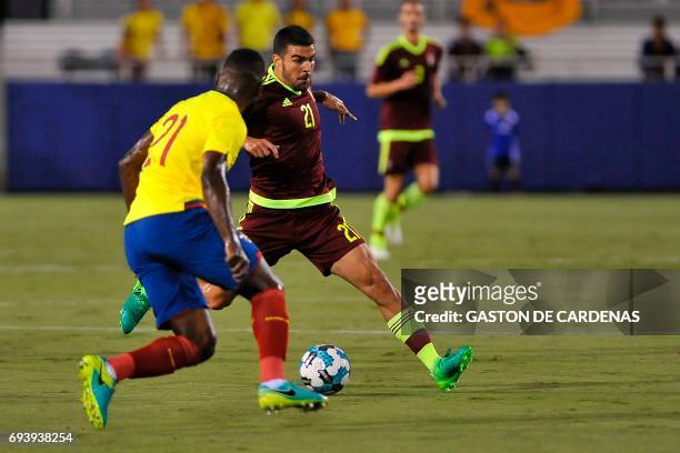 Venezuela's Alexander Gonzalez vies for the ball against Gabriel Achiller of Ecuador during their friendly soccer match at FAU stadium in Boca Raton,...