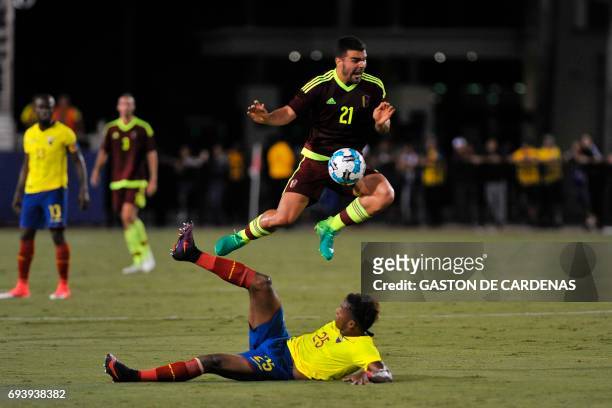 Venezuela's Alexander Gonzalez challenges for the ball against Dario Aimar during their friendly soccer match at FAU stadium in Boca Raton, Florida...