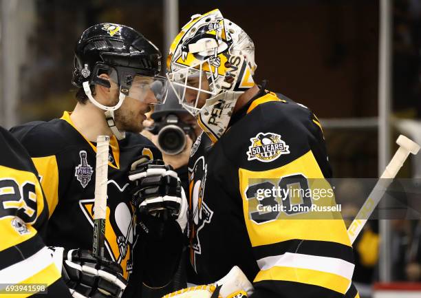 Goaltender Matt Murray of the Pittsburgh Penguins is congratulated by teammate Sidney Crosby after their 6-0 victory over the Nashville Predators in...