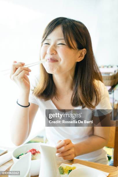 young japanese woman having lunch - 30s woman eating stock pictures, royalty-free photos & images