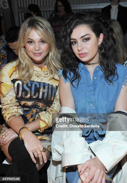 Actor Olivia Holt and singer Charli XCX attend Moschino Spring/Summer 18 Menswear and Women's Resort Collection at Milk Studios on June 8, 2017 in...