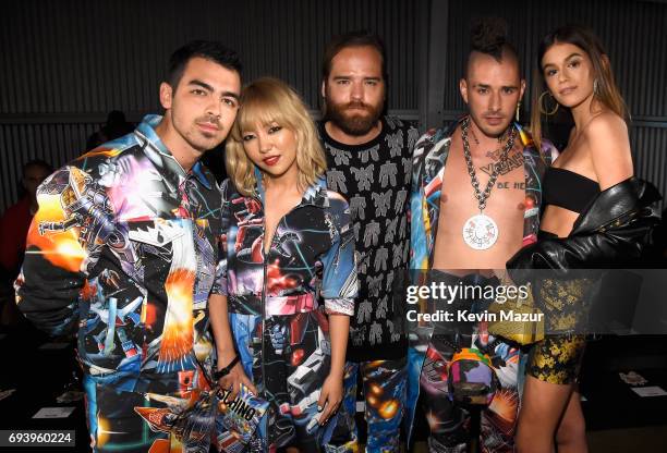 Musicians Joe Jonas, JinJoo Lee, Jack Lawless and Cole Whittle of DNCE and model Kaia Gerber attend Moschino Spring/Summer 18 Menswear and Women's...