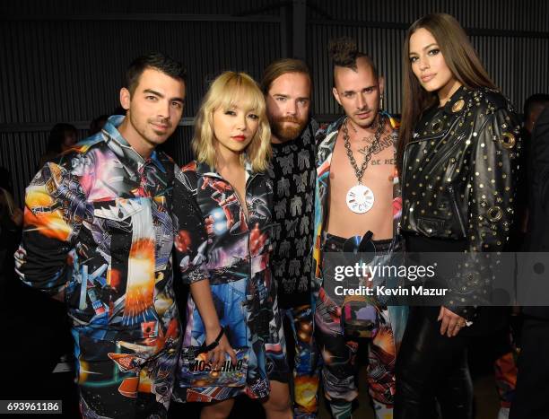 Musicians Joe Jonas, JinJoo Lee, Jack Lawless, Cole Whittle of DNCE and model Ashley Graham attend Moschino Spring/Summer 18 Menswear and Women's...