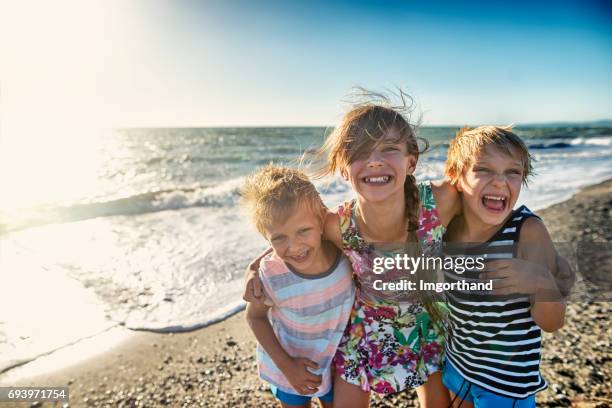 kids enjoying tuscan beach - children only laughing stock pictures, royalty-free photos & images