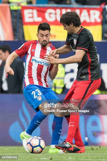 Nicolas Gaitan of Atletico de Madrid fights for the ball with Mikel San Jose Dominguez of Athletic Club during the La Liga match between Atletico de...