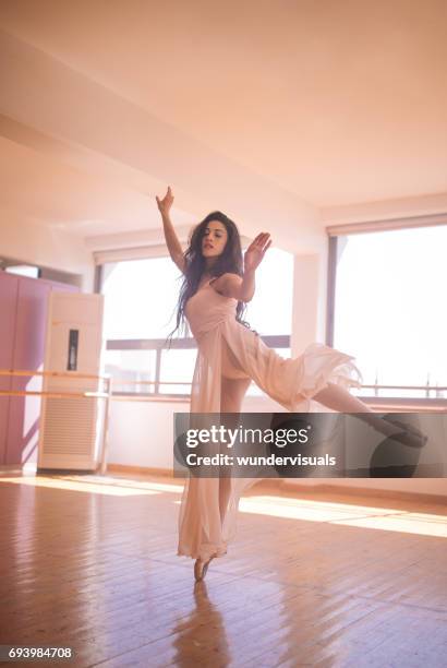 young female dancer in ballet pose - leotard and tights stock pictures, royalty-free photos & images