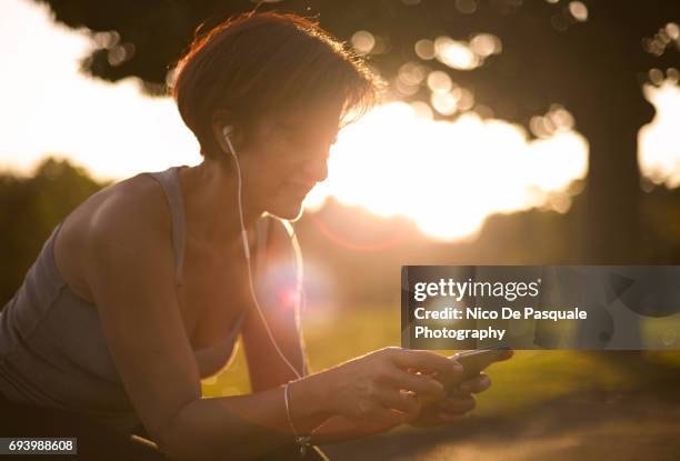 female runner at the park - running paris stock-fotos und bilder