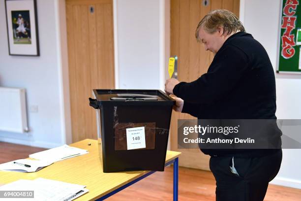 An official seals an empty ballot box before voting can begin at a polling station in Stalybridge on June 8, 2017 in Greater Manchester, United...