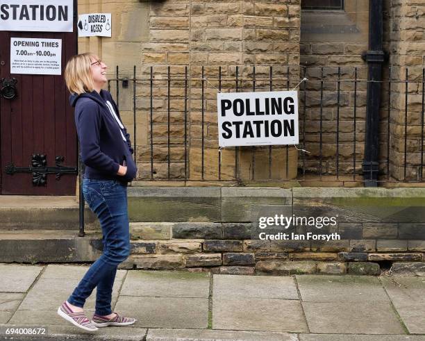Woman reacts as she meets a friend outside a polling station on June 8, 2017 in Saltburn-by-the-Sea, United Kingdom. Polling stations open across the...