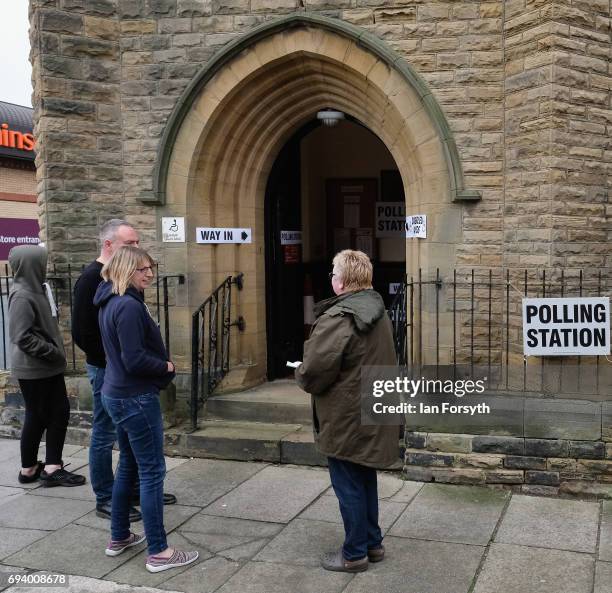 People wait for a polling station to open on June 8, 2017 in Saltburn-by-the-Sea, United Kingdom. Polling stations open across the country as the...