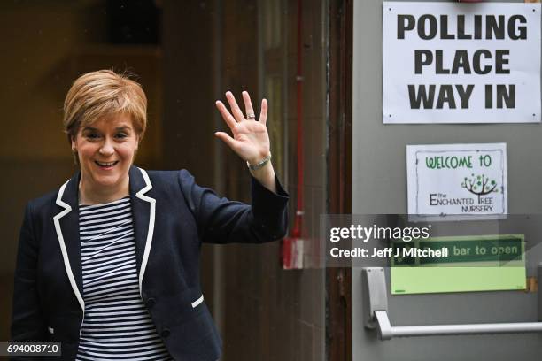 Leader Nicola Sturgeon exits after casting her vote in the general election with her husband Peter Murrel at Broomhouse Community Hall on June 8,...