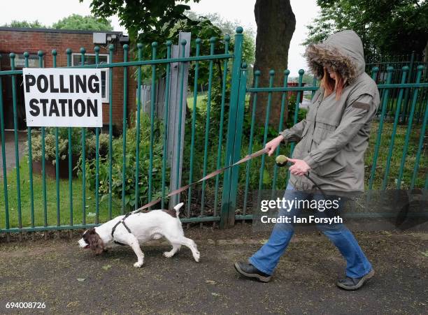 Woman walks her dog past a polling station on June 8, 2017 in Carlin How, United Kingdom. Polling stations open across the country as the United...