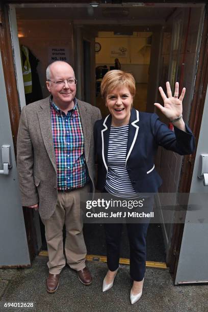 Leader Nicola Sturgeon exits after casting her vote in the general election with her husband Peter Murrel at Broomhouse Community Hall on June 8,...