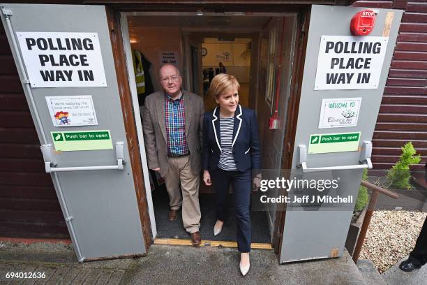 Leader Nicola Sturgeon exits after casting her vote in the general election with her husband Peter Murrel at Broomhouse Community Hall on June 8,...