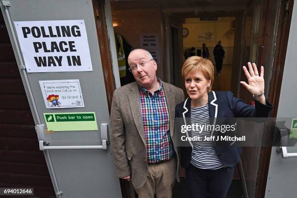 Leader Nicola Sturgeon exits after casting her vote in the general election with her husband Peter Murrel at Broomhouse Community Hall on June 8,...