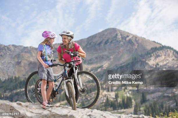 caucasian grandmother and granddaughter with mountain bikes - girl mound stock-fotos und bilder