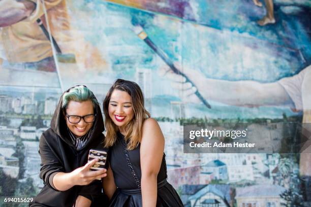 smiling asian women posing for cell phone selfie - oakland california bildbanksfoton och bilder