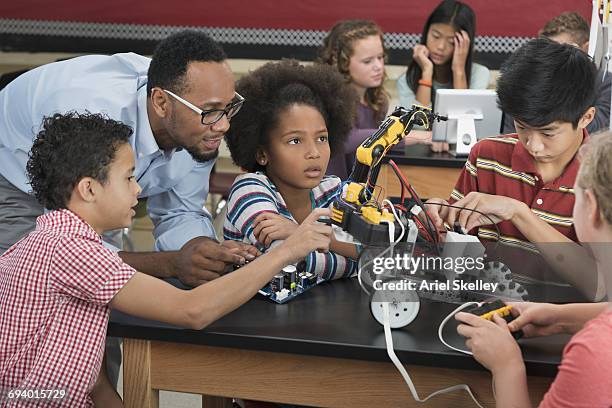 teacher helping students in robotics class - stem education stock pictures, royalty-free photos & images