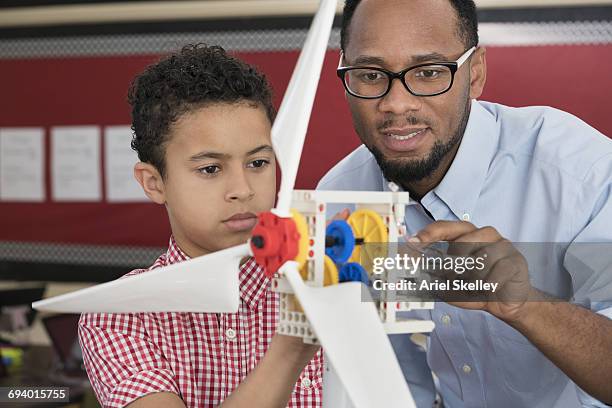 teacher helping student with model wind turbine - science teacher stock pictures, royalty-free photos & images