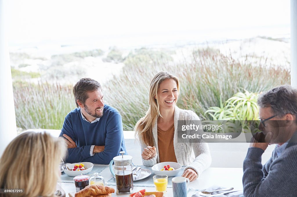 Couples enjoying breakfast on beach patio