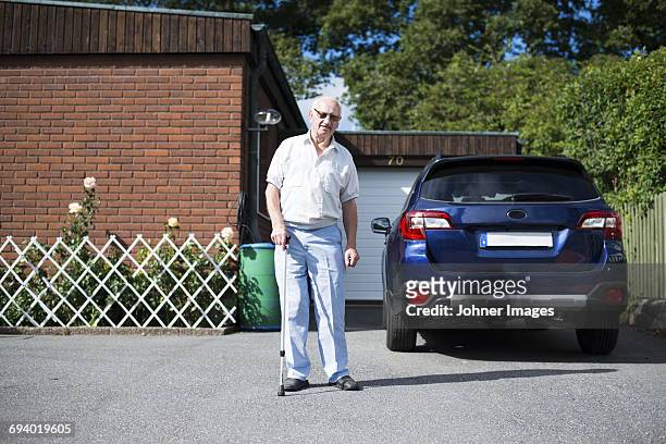 senior man in front of car - auto garage foto e immagini stock