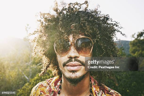 portrait of mixed race man wearing sunglasses - man sunglasses face imagens e fotografias de stock