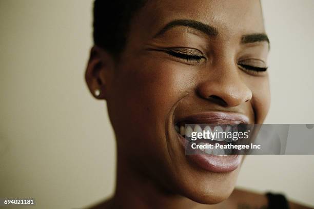 portrait of face of laughing black woman - toothy smile stock pictures, royalty-free photos & images