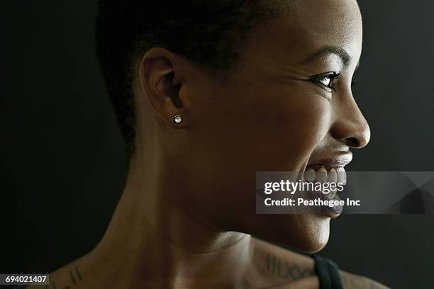 profile of smiling black woman - shoulder detail ストックフォトと画像
