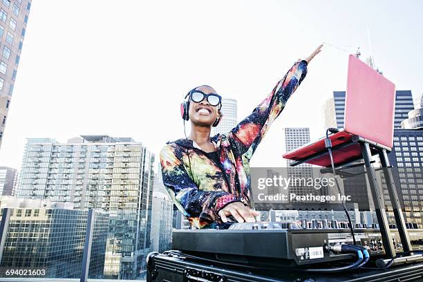 smiling black dj on urban rooftop - dj ストックフォトと画像