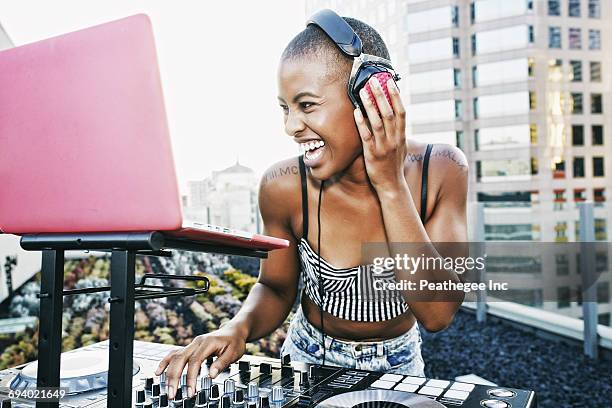 black dj laughing on urban rooftop - dj stockfoto's en -beelden