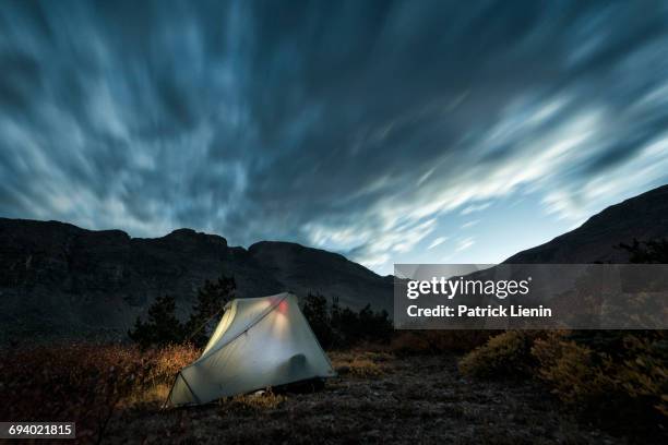 illuminated camping tent under cloudy sky - denver sunset stock pictures, royalty-free photos & images