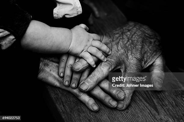 three people holding hands together - black and white photo stock pictures, royalty-free photos & images