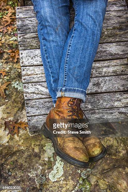 legs of caucasian woman wearing jeans and boots - adirondack chair closeup stock pictures, royalty-free photos & images