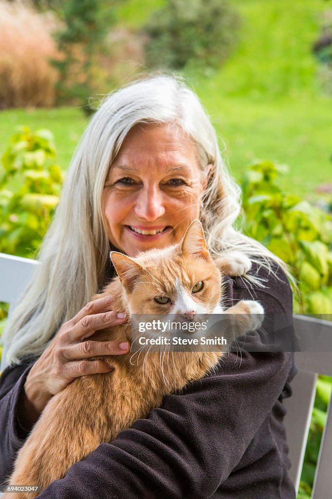 Portrait of smiling Caucasian woman holding cat