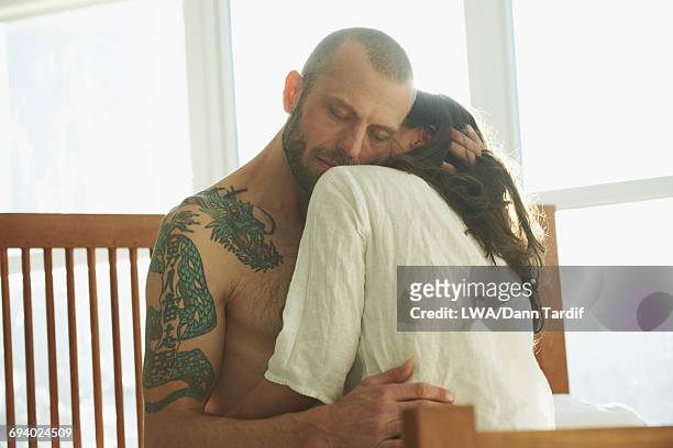 caucasian couple hugging in bed - white dragon tattoo stock pictures, royalty-free photos & images